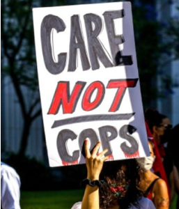 "Protest sign reading Care not cops."